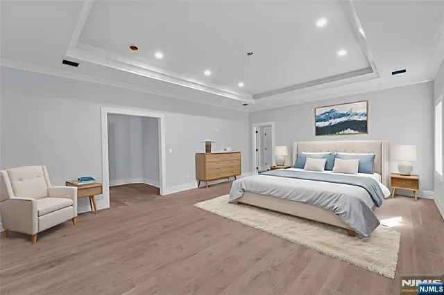 a spacious bathroom with a tub sink and mirror