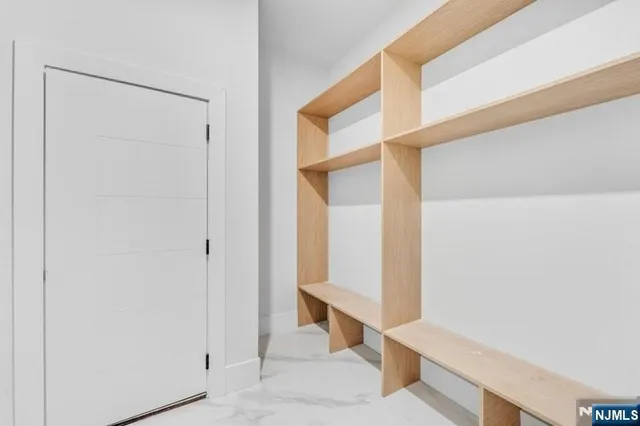 a view of empty room with cabinet and window