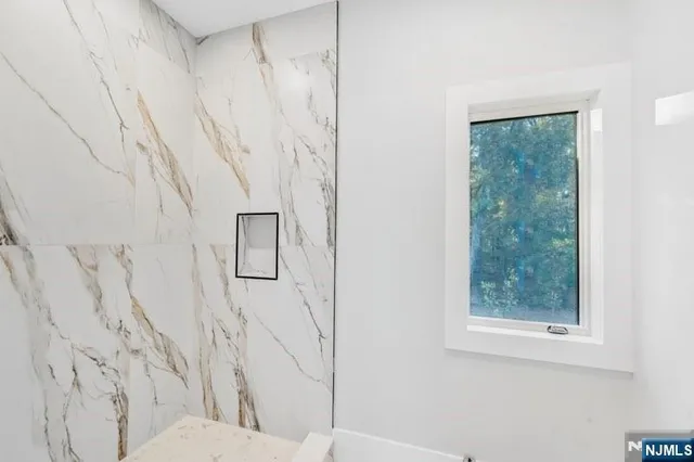 a view of a house with a big yard and large trees