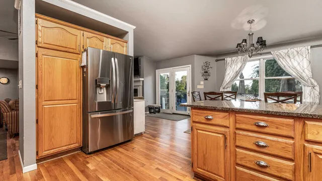 a kitchen with granite countertop a refrigerator and a sink