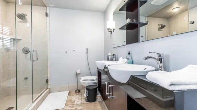 a bathroom with a sink a toilet and shower