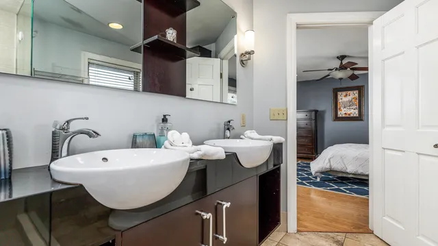 a bedroom with bed and a chandelier