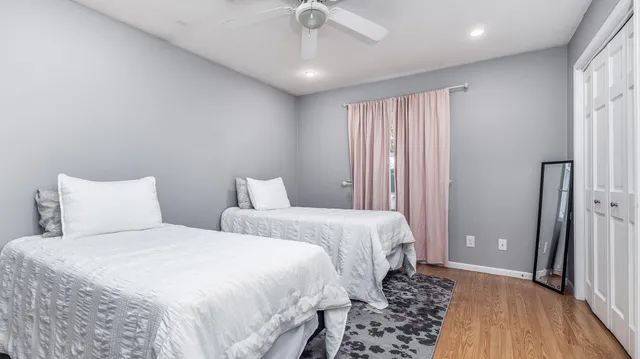 a bedroom with two beds and a night stand