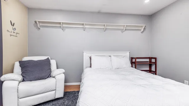 a bedroom with a bed and a chandelier