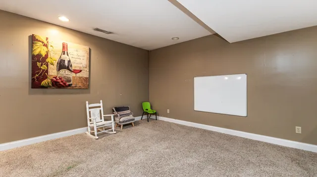 a kitchen with stainless steel appliances kitchen island a table chairs in it and wooden floors