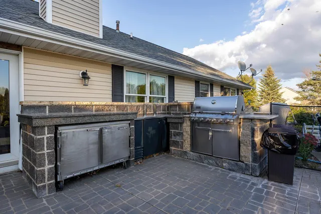 a front view of a house with yard and green space
