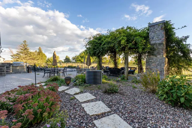 a view of a patio with couches table and chairs and potted plants