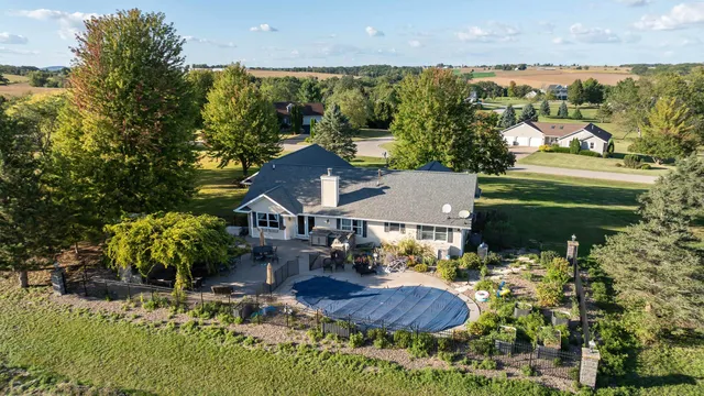 a view of house with garden space and lake view