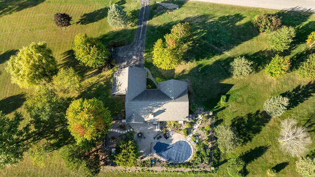 an aerial view of a residential houses with yard