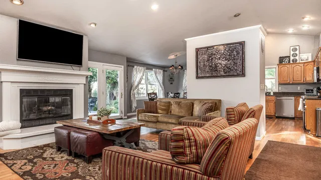a living room with furniture fireplace and flat screen tv