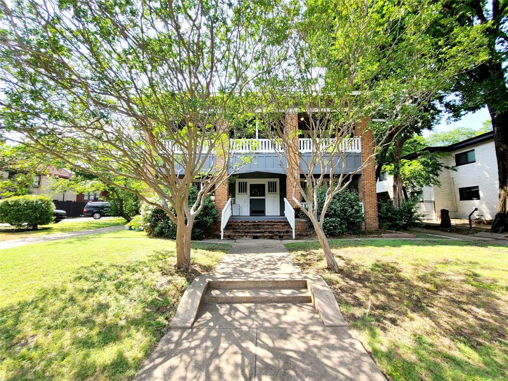 4911 Worth Street, Unit 4 Dallas, TX 75214 - Photo 1 of 28 a front view of a house with a garden and trees