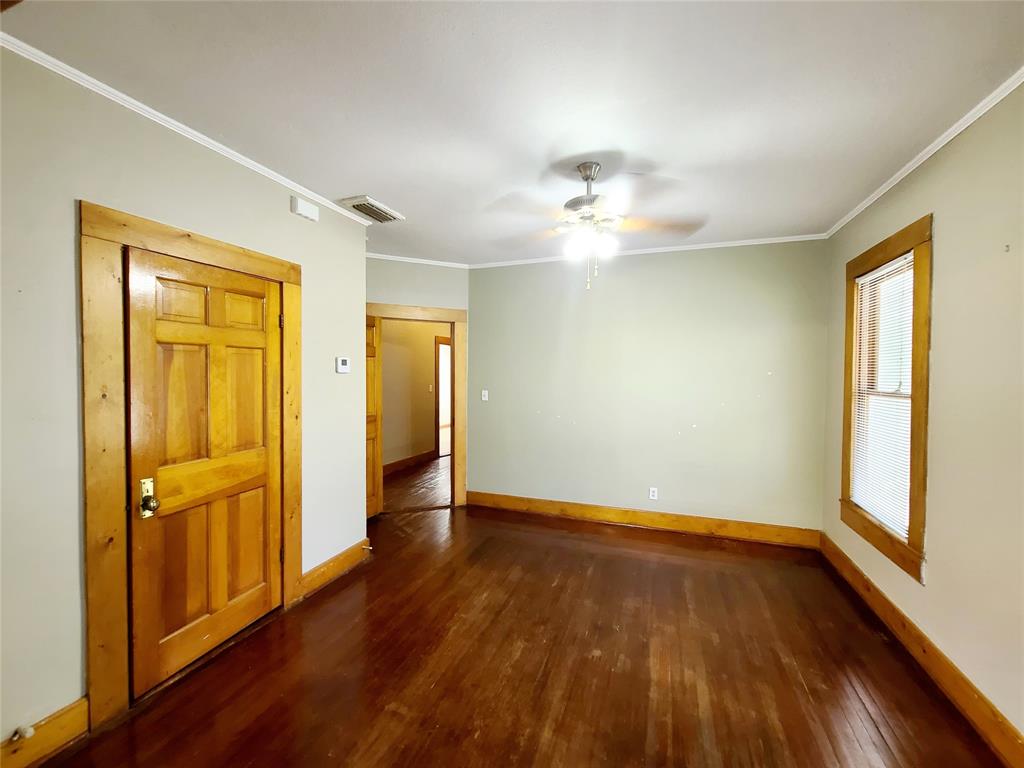 4911 Worth Street, Unit 4 Dallas, TX 75214 - Photo 12 of 28 an empty room with wooden floor and windows
