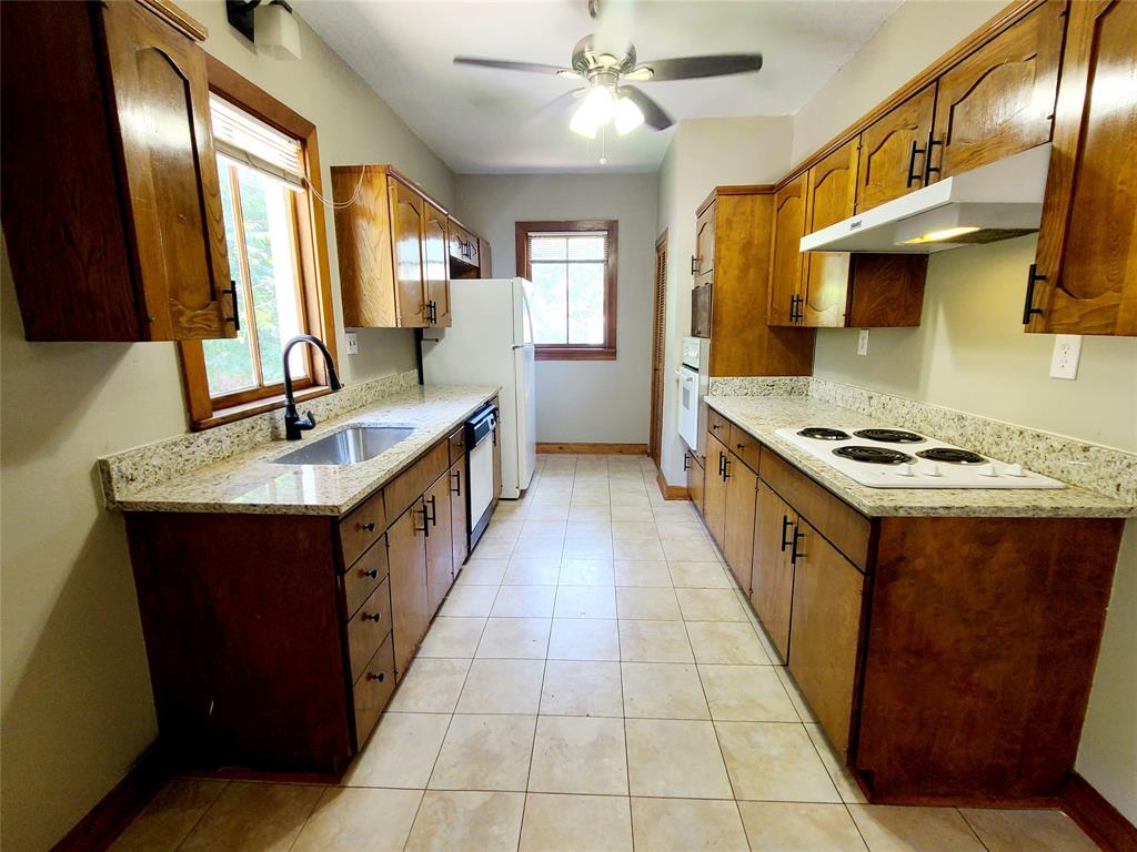 4911 Worth Street, Unit 4 Dallas, TX 75214 - Photo 14 of 28 a kitchen with stainless steel appliances a sink stove and cabinets
