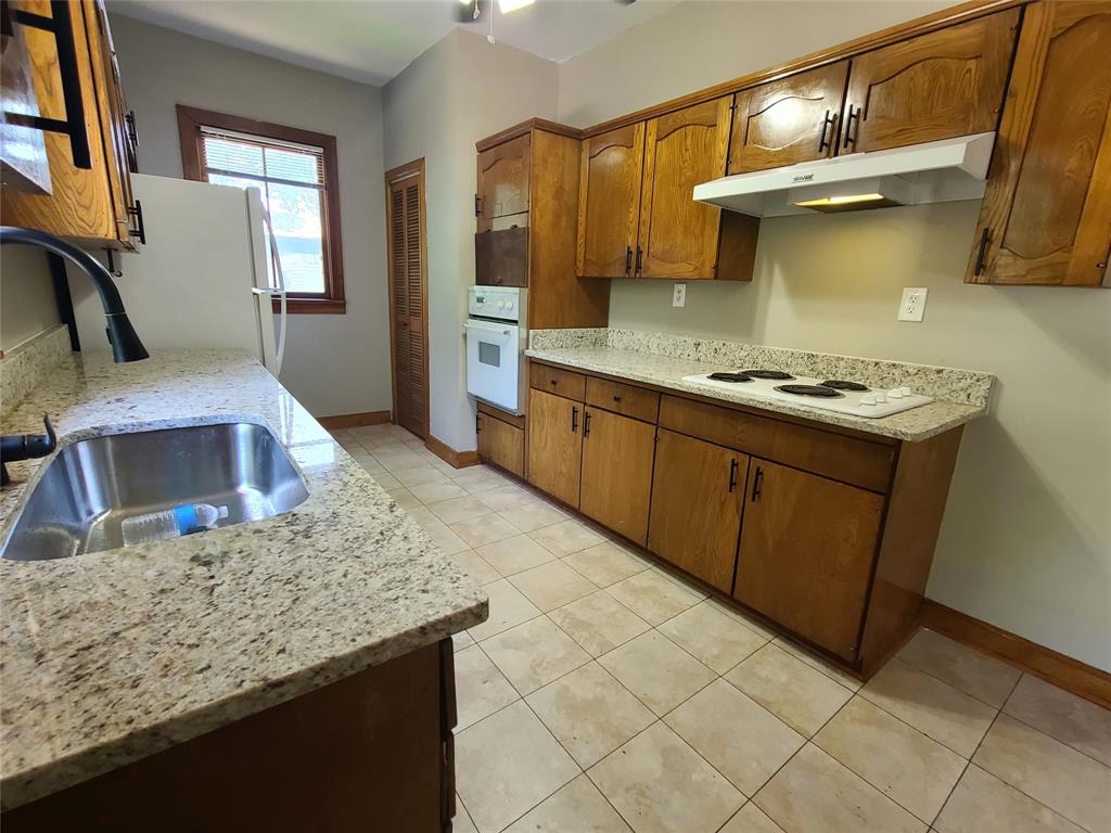 4911 Worth Street, Unit 4 Dallas, TX 75214 - Photo 15 of 28 a kitchen with stainless steel appliances granite countertop a sink stove and refrigerator