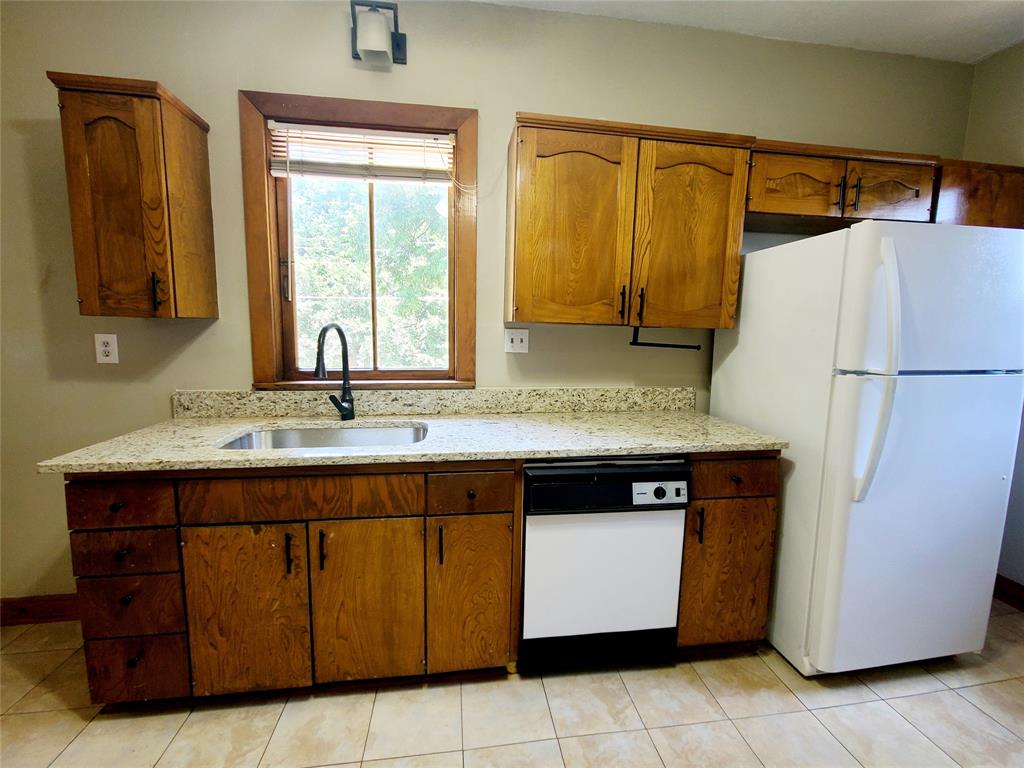 4911 Worth Street, Unit 4 Dallas, TX 75214 - Photo 16 of 28 a kitchen with a refrigerator and a sink