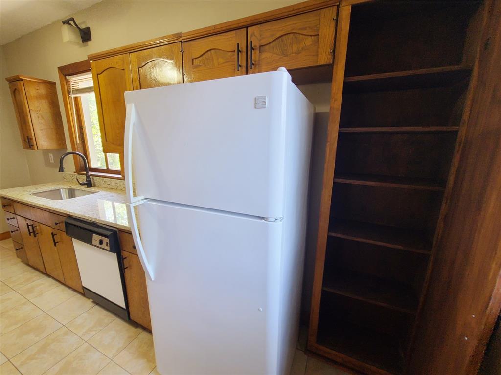 4911 Worth Street, Unit 4 Dallas, TX 75214 - Photo 17 of 28 a white refrigerator freezer and a stove sitting inside of a kitchen