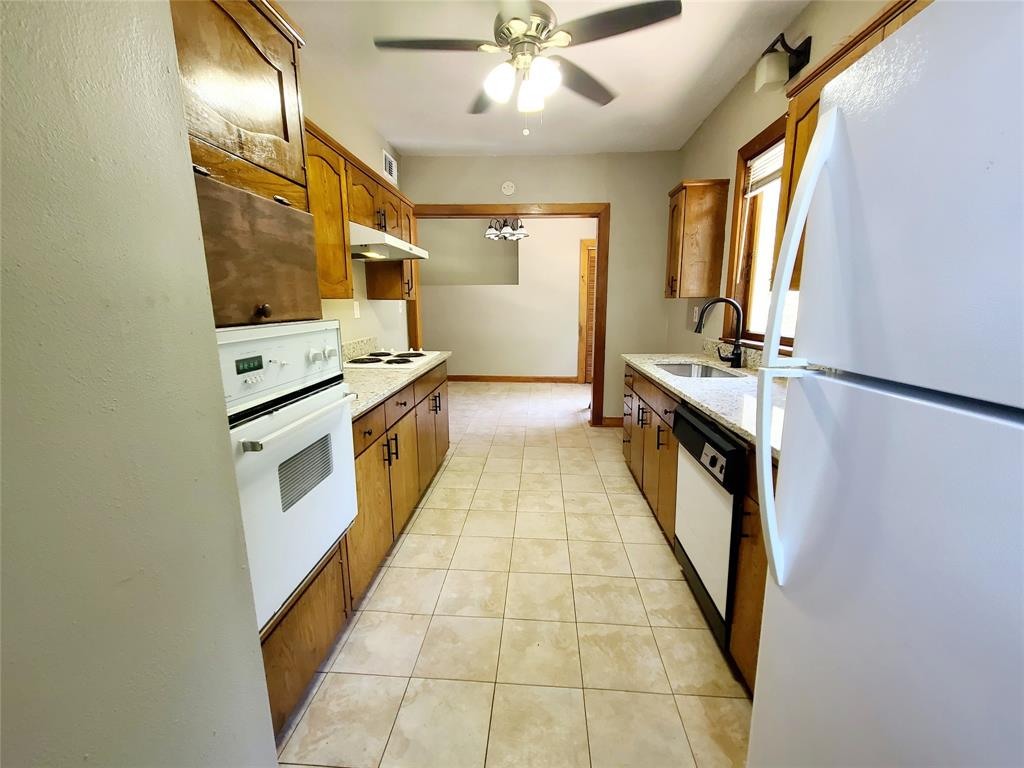 4911 Worth Street, Unit 4 Dallas, TX 75214 - Photo 18 of 28 a kitchen with stainless steel appliances granite countertop a stove and a refrigerator