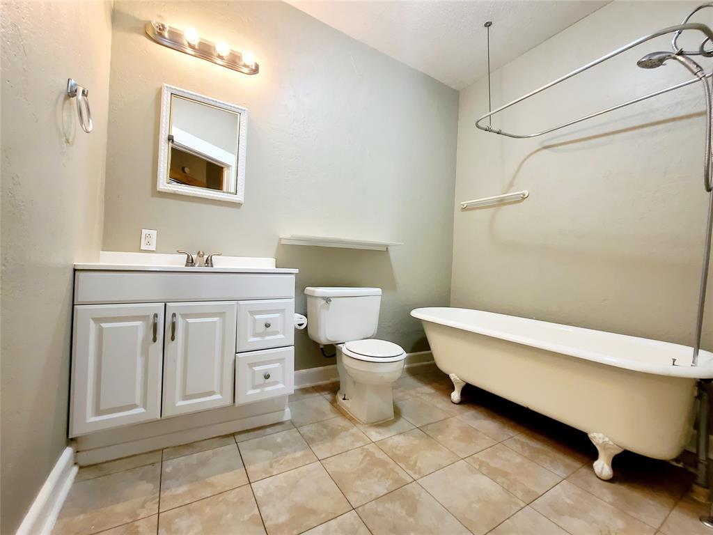 4911 Worth Street, Unit 4 Dallas, TX 75214 - Photo 20 of 28 a bathroom with a toilet sink and mirror