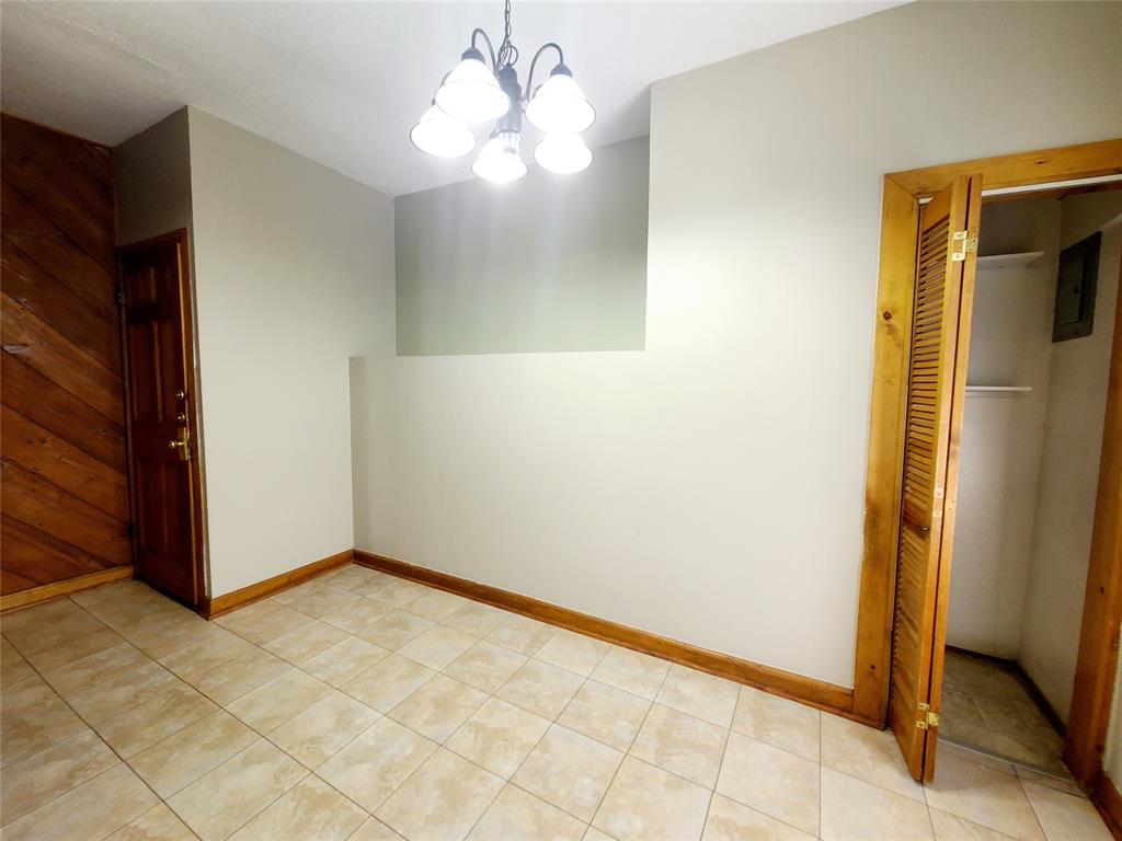 4911 Worth Street, Unit 4 Dallas, TX 75214 - Photo 23 of 28 a view of an empty room with window and chandelier fan