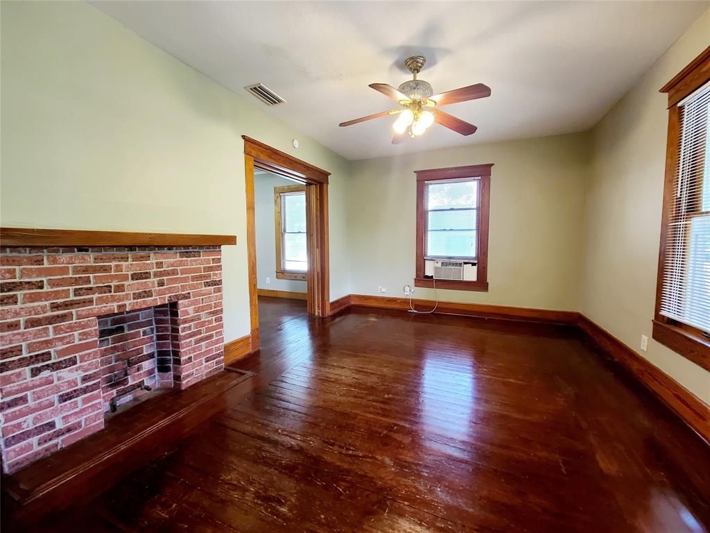 4911 Worth Street, Unit 4 Dallas, TX 75214 - Photo 6 of 28 a view of an empty room with wooden floor and a window