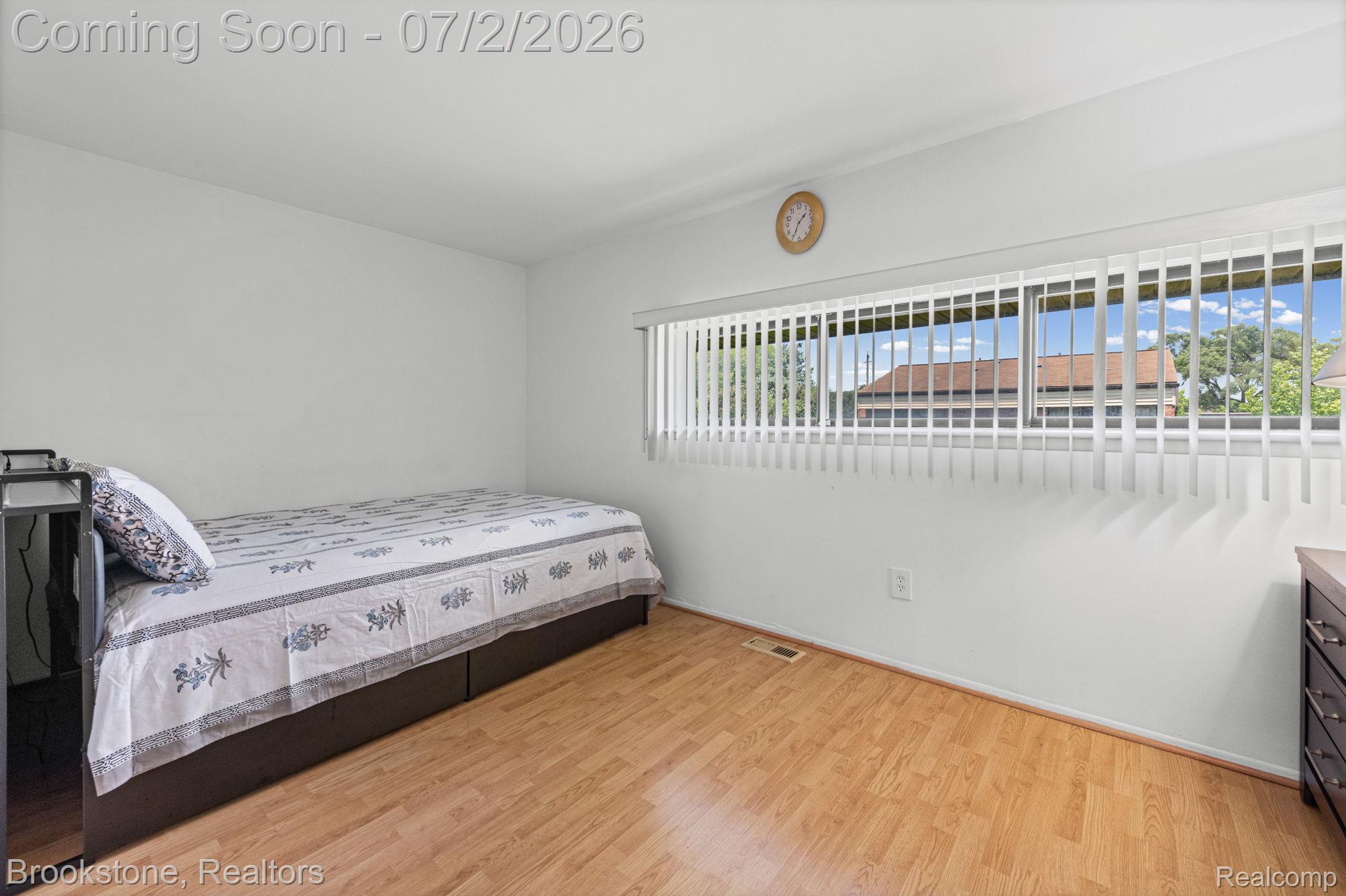 1925 Nicholas Court Warren, MI 48092 - Photo 16 of 26 Bright room featuring wood-finish flooring, white walls, and a window with vertical blinds