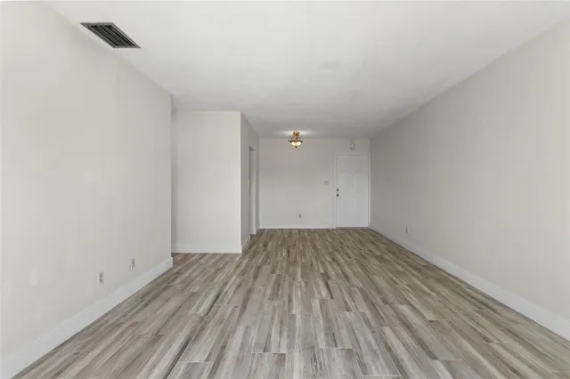 an empty room with wooden floor