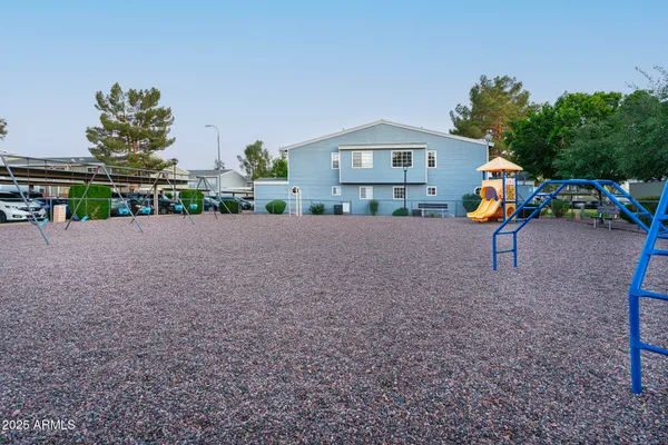 a view of a house with swimming pool and a yard