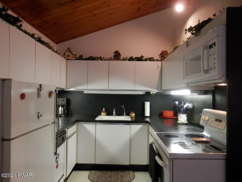 112 Squirrel Road Dingmans Ferry, PA 18328 - Photo 5 of 26 a kitchen with a cabinets and white appliances