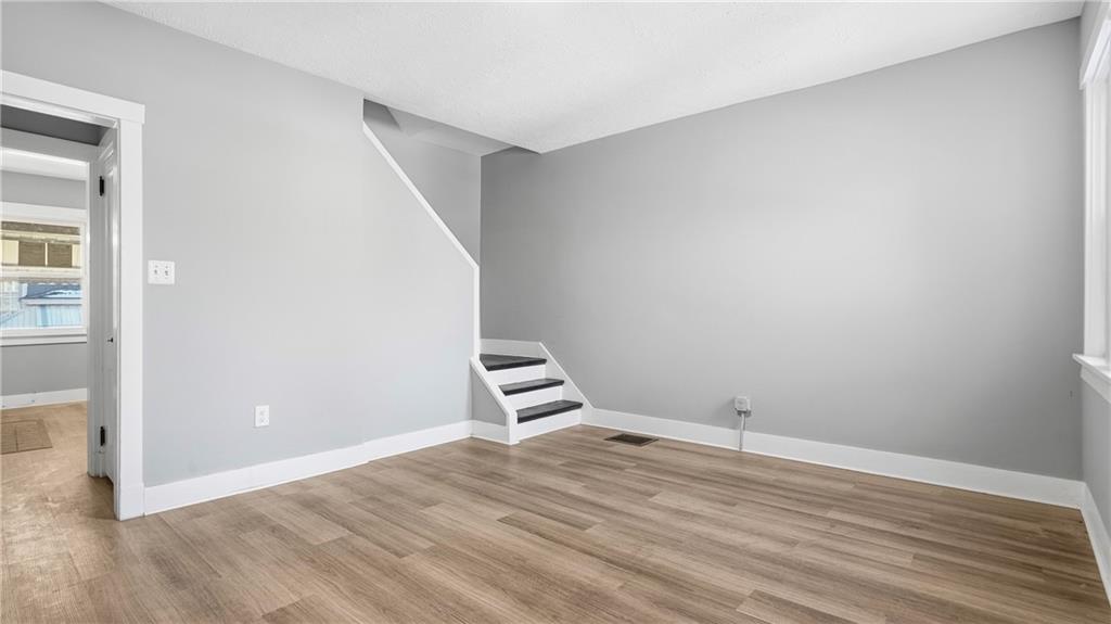 613 Paulson Avenue Pittsburgh, PA 15206 - Photo 12 of 32 an empty room with wooden floor