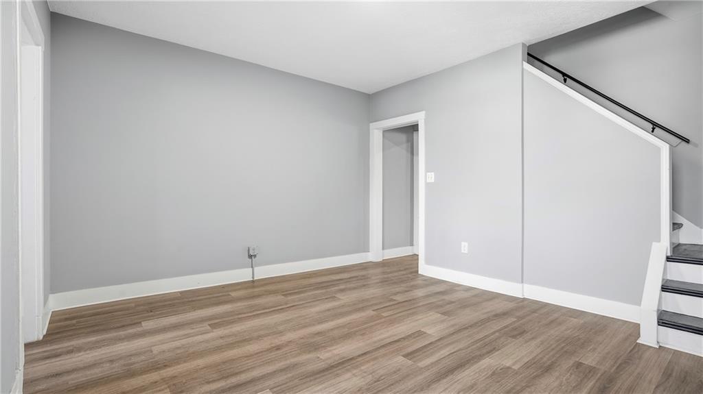613 Paulson Avenue Pittsburgh, PA 15206 - Photo 13 of 32 a view of an empty room with wooden floor and a window