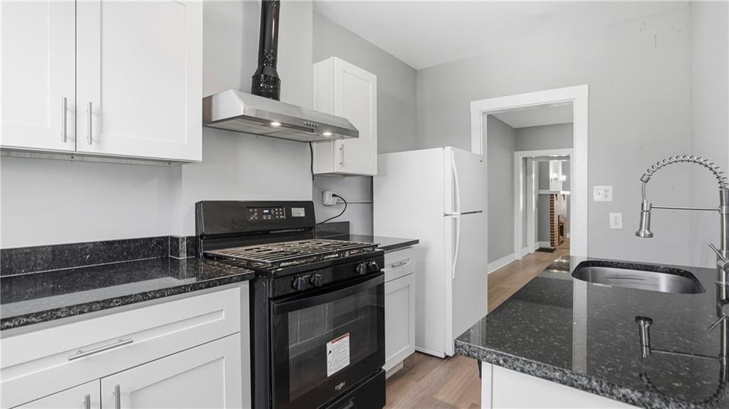 613 Paulson Avenue Pittsburgh, PA 15206 - Photo 18 of 32 a kitchen with stainless steel appliances granite countertop a sink stove and refrigerator