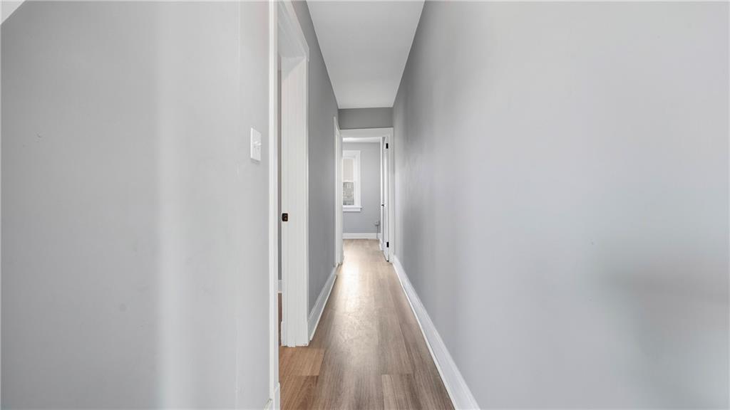 613 Paulson Avenue Pittsburgh, PA 15206 - Photo 19 of 32 a view of a hallway with wooden floor