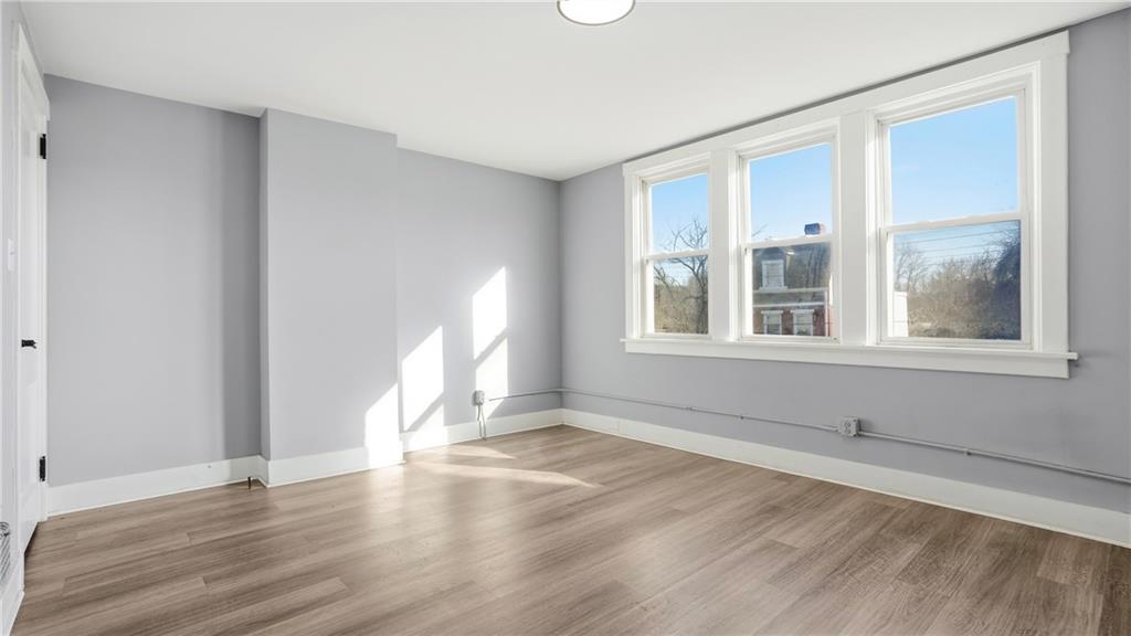 613 Paulson Avenue Pittsburgh, PA 15206 - Photo 21 of 32 a view of empty room with wooden floor and fan