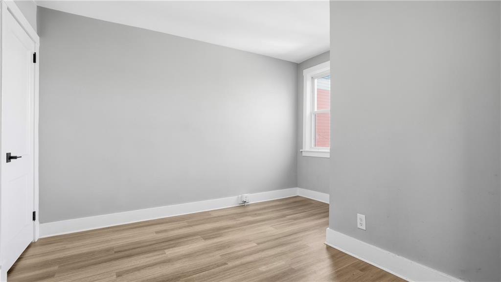 613 Paulson Avenue Pittsburgh, PA 15206 - Photo 23 of 32 a view of an empty room with wooden floor and a window