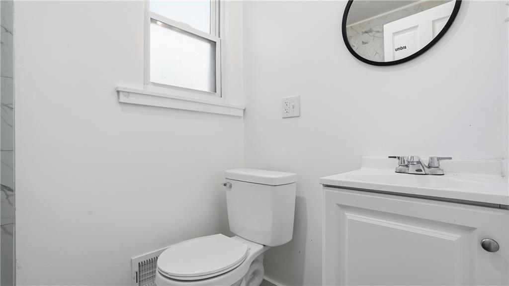 613 Paulson Avenue Pittsburgh, PA 15206 - Photo 26 of 32 a bathroom with a toilet a sink and a mirror