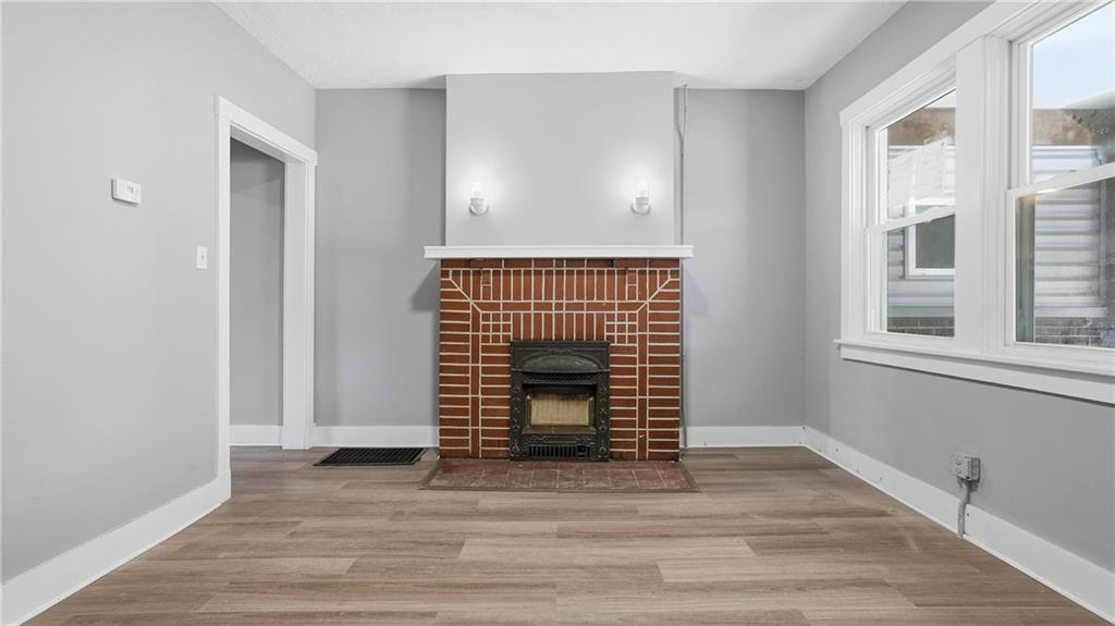 613 Paulson Avenue Pittsburgh, PA 15206 - Photo 8 of 32 a view of an empty room with wooden floor and a window