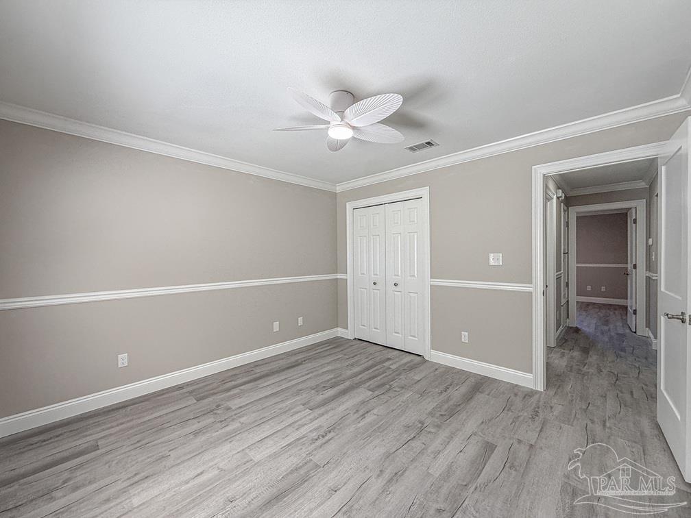 4412 Copperwood Place Pace, FL 32571 - Photo 24 of 32 an empty room with closet and a ceiling fan