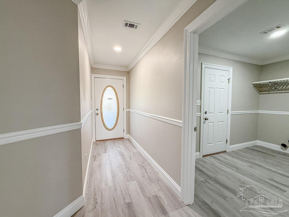 4412 Copperwood Place Pace, FL 32571 - Photo 6 of 32 a view of a room with wooden floor and white walls