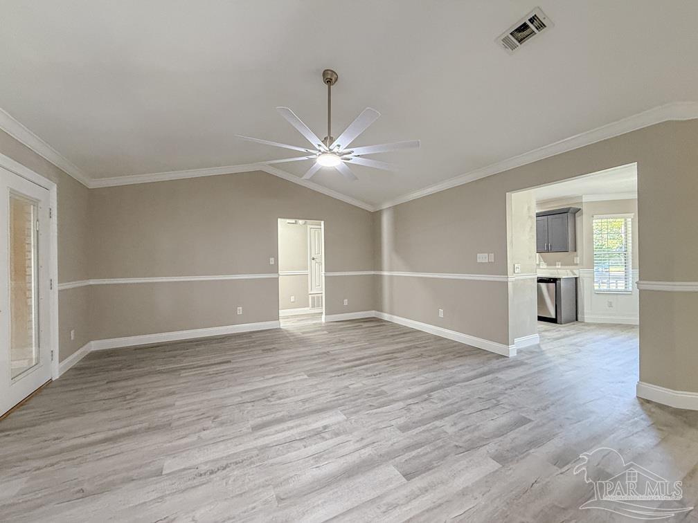 4412 Copperwood Place Pace, FL 32571 - Photo 10 of 32 an empty room with wooden floor and windows