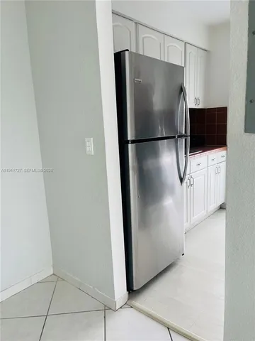 a kitchen with stainless steel appliances a refrigerator and a stove