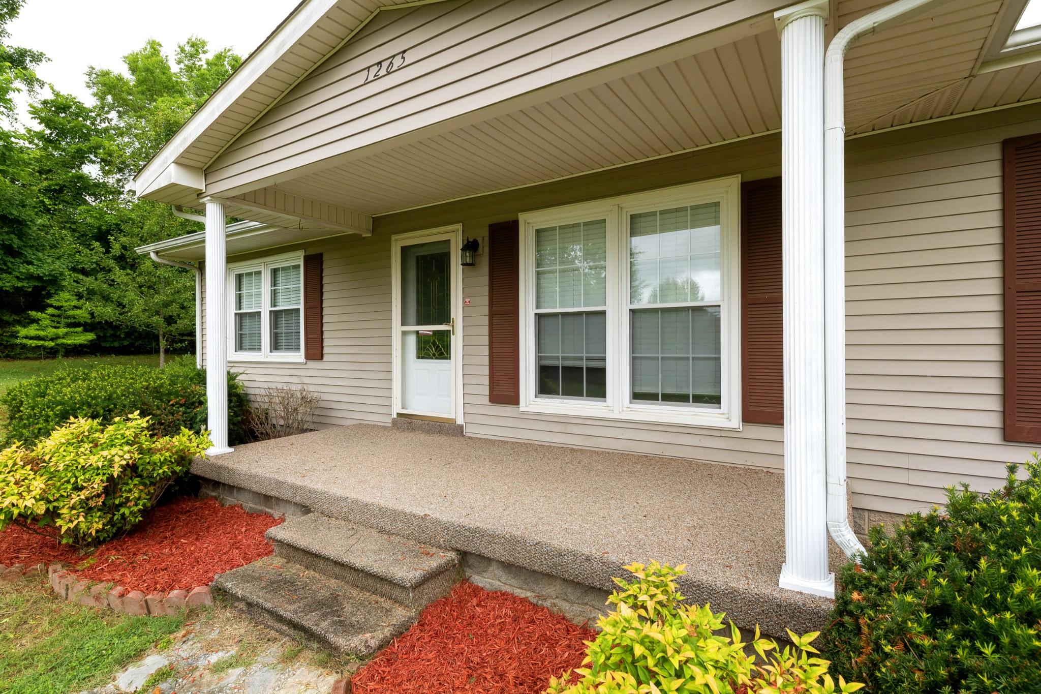 1265 Iron Bridge Road Columbia, TN 38401 - Photo 2 of 34 a front view of a house with garden