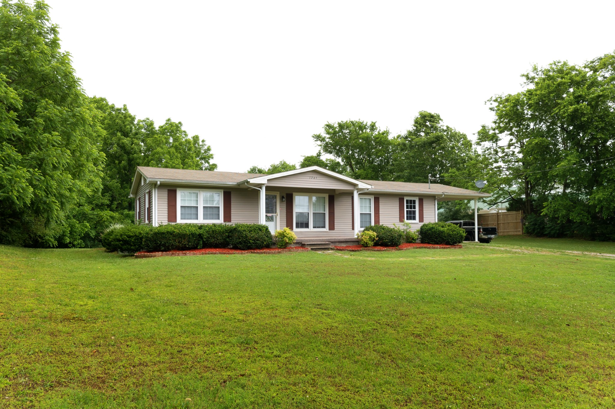 1265 Iron Bridge Road Columbia, TN 38401 - Photo 6 of 34 a front view of a house with a garden
