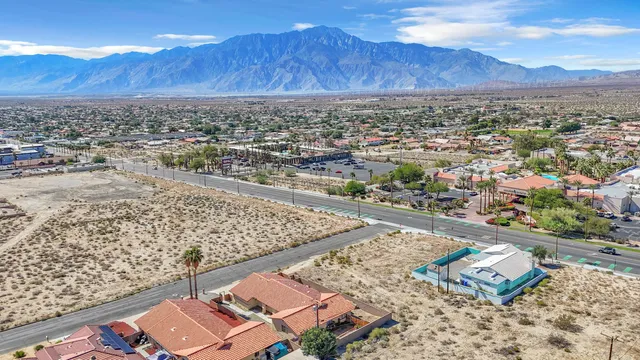 an aerial view of city and mountain
