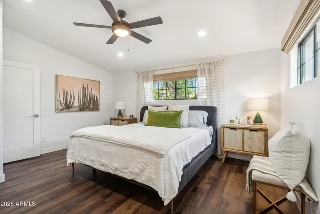 a bedroom with a bed and wooden floor