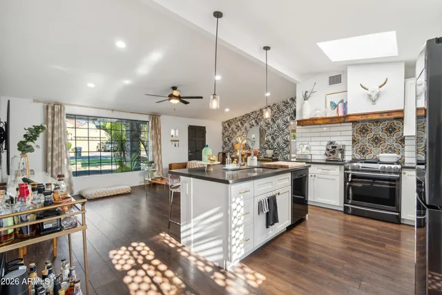 a kitchen with stainless steel appliances granite countertop a stove and cabinets
