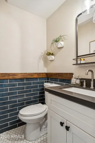 a bathroom with a toilet a sink and mirror