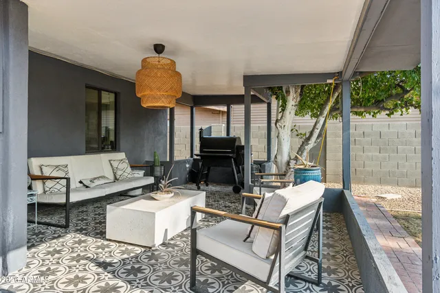 a living room with furniture and a floor to ceiling window