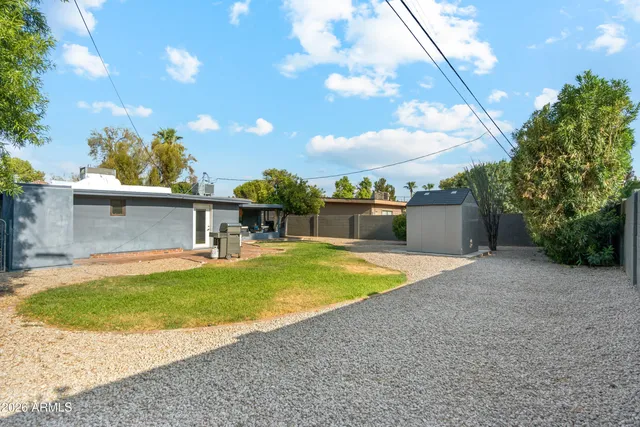 a view of a backyard with swimming pool