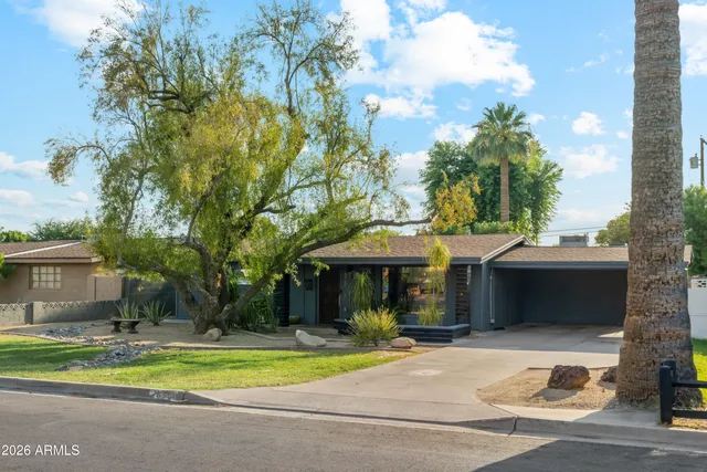 a view of a house with a yard and sitting area