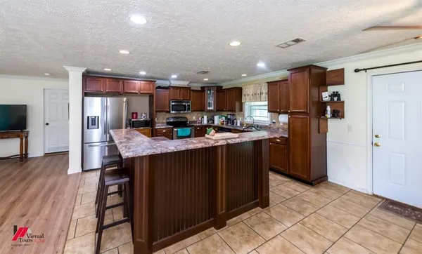 a kitchen with refrigerator and cabinets